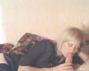 Mature lady giving head while watching TV